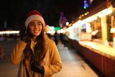 Young woman spending time at Christmas fair, space for text Photo of Young woman spending time at Christmas fair, space for text
