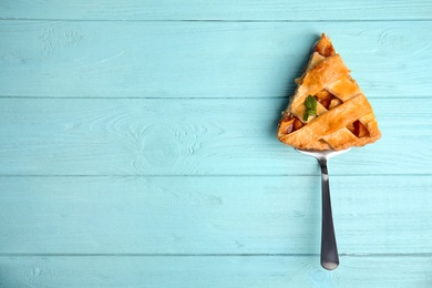 Slice of delicious fresh peach pie on light blue wooden table, top view. Space for text Photo of Slice of delicious fresh peach pie on light blue wooden table, top view. Space for text