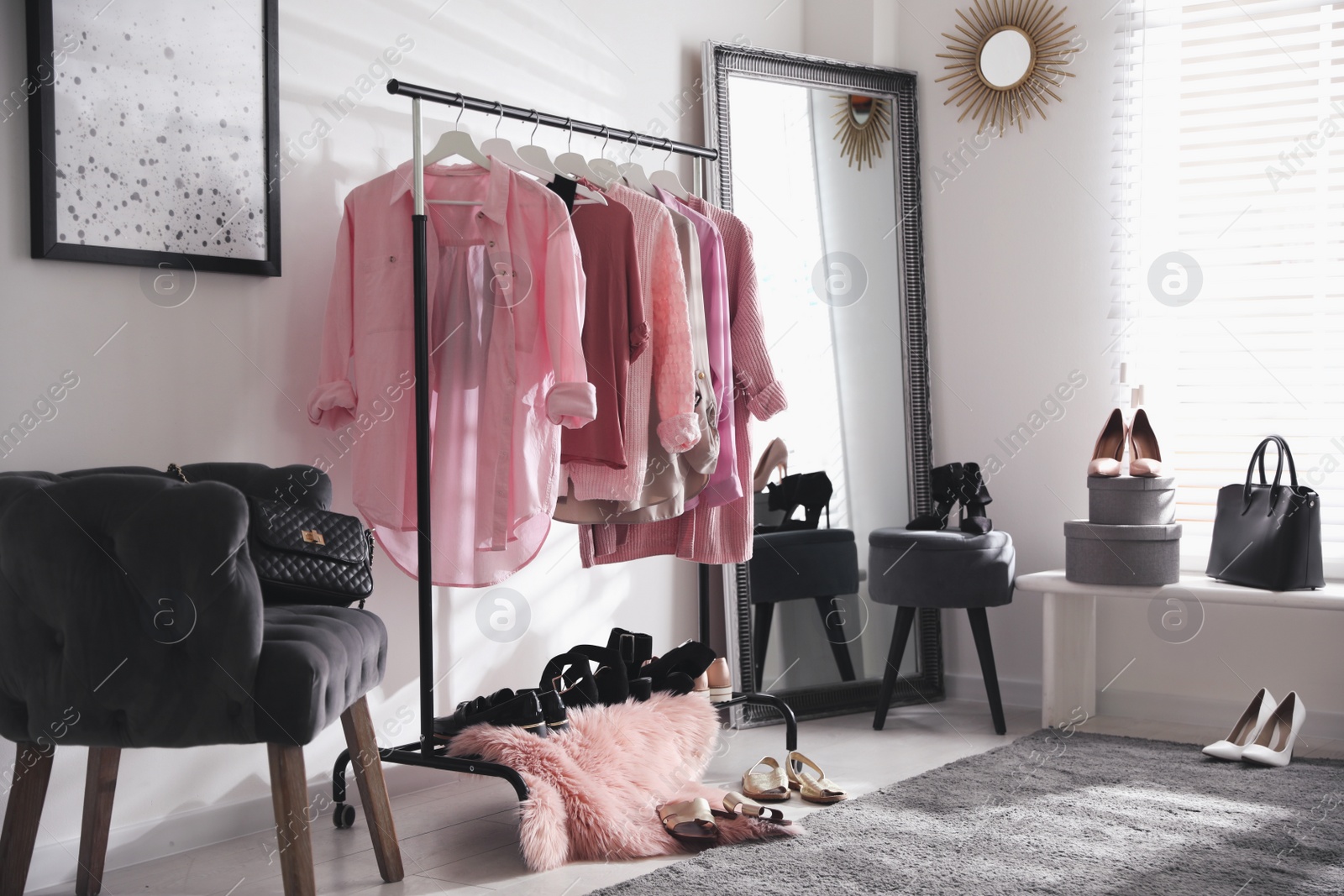 Dressing room interior with clothing rack and comfortable chair Photo of Dressing room interior with clothing rack and comfortable chair