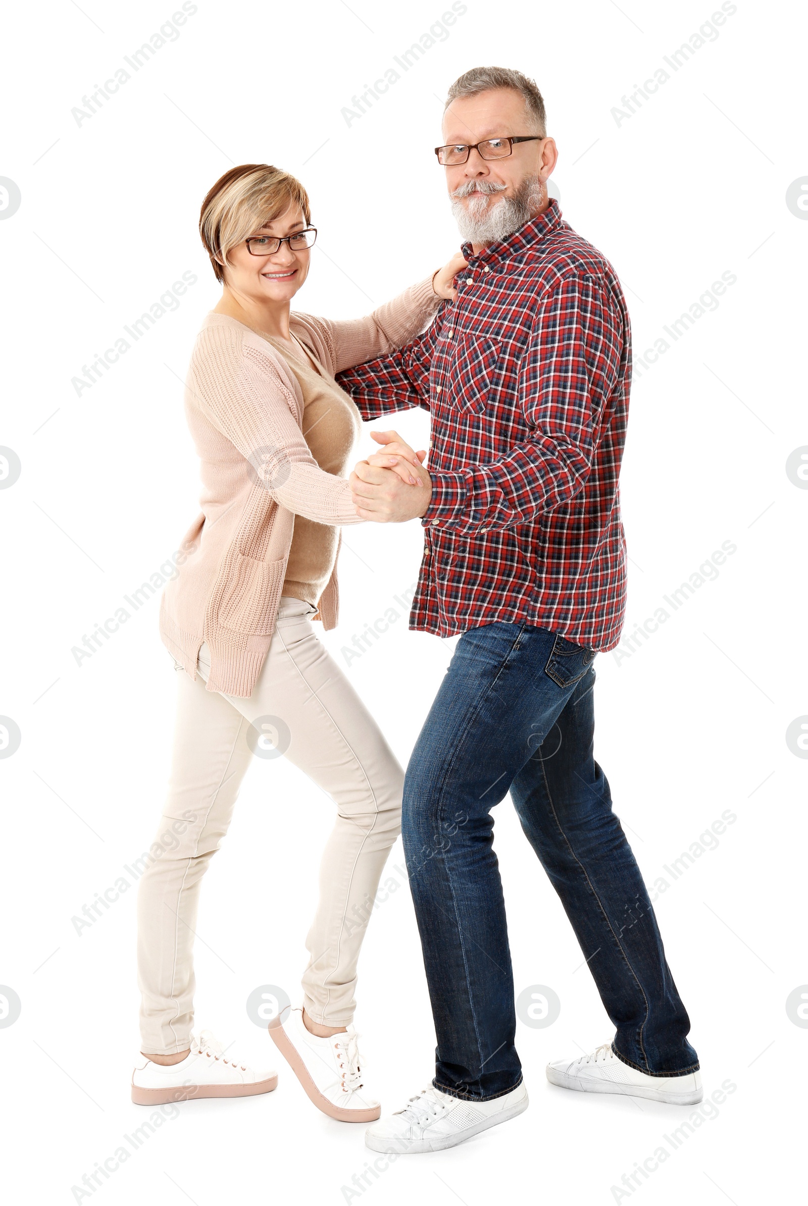 Happy senior couple dancing on white background Photo of Happy senior couple dancing on white background