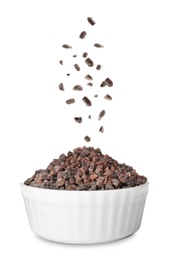 Black salt crystals falling into bowl on white background Image of Black salt crystals falling into bowl on white background