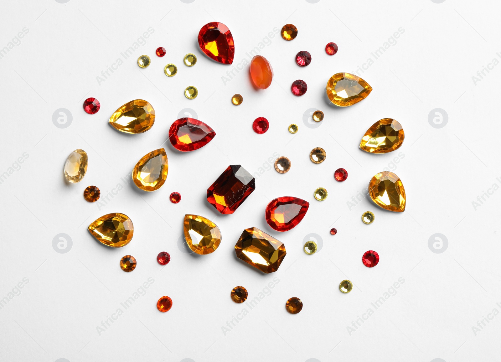 Different beautiful gemstones on white background, top view Image of Different beautiful gemstones on white background, top view