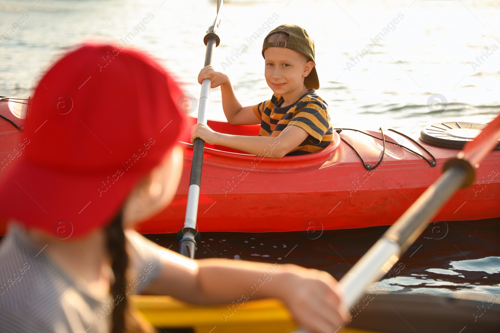 Little children kayaking on river. Summer camp activity Photo of Little children kayaking on river. Summer camp activity