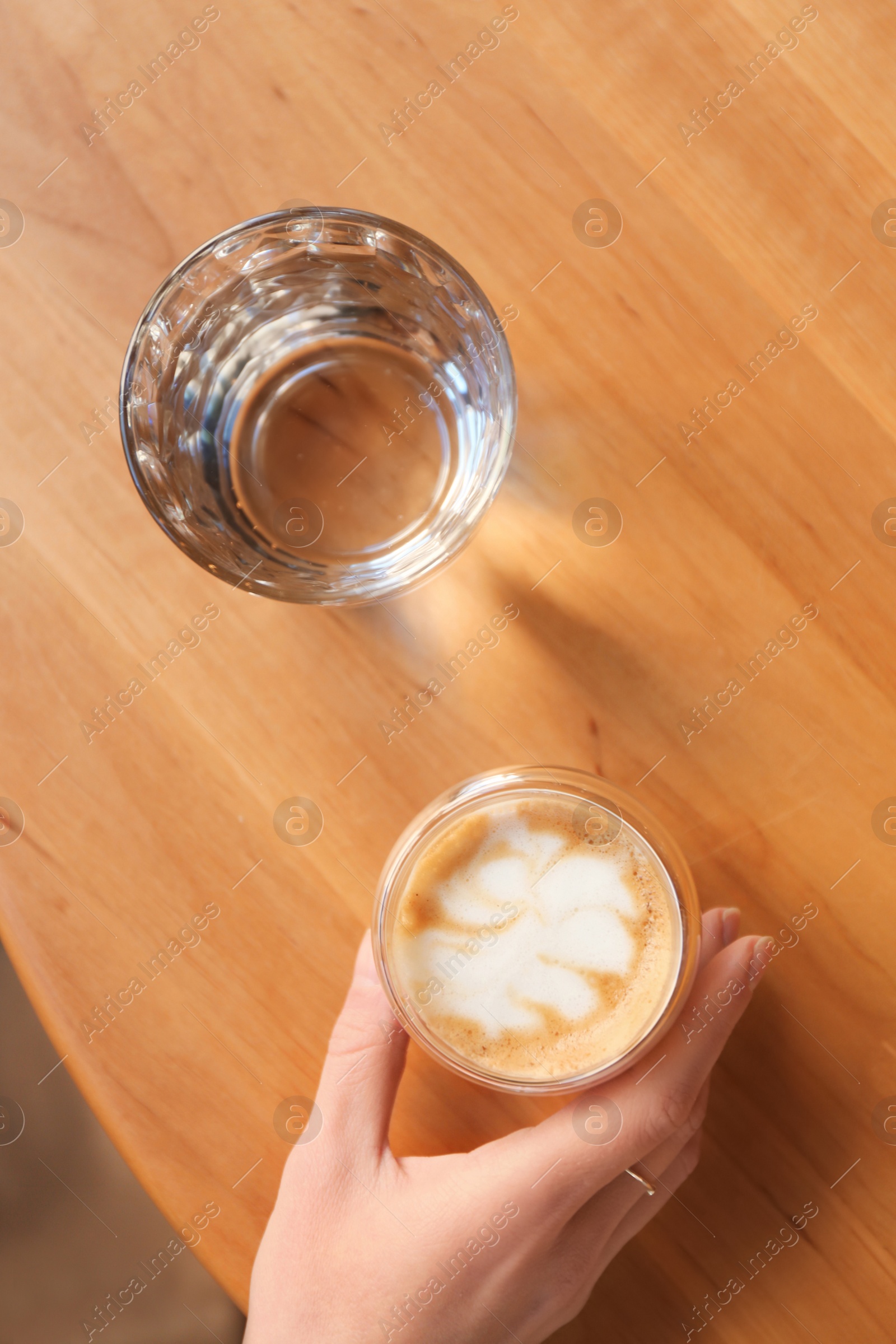 Woman with aromatic coffee at table in cafe, top view Photo of Woman with aromatic coffee at table in cafe, top view