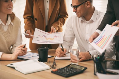 Businesspeople having meeting in office, closeup. Management consulting Photo of Businesspeople having meeting in office, closeup. Management consulting