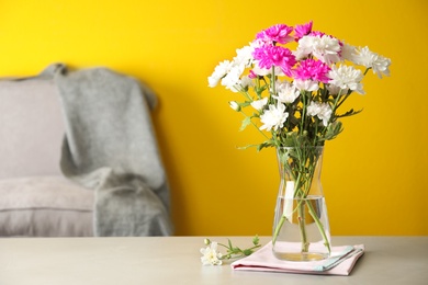 Beautiful bouquet of Chrysanthemum flowers on grey table indoors, space for text. Interior design Photo of Beautiful bouquet of Chrysanthemum flowers on grey table indoors, space for text. Interior design