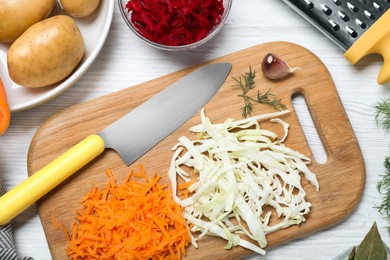 Fresh ingredients for borscht on white wooden table, flat lay Photo of Fresh ingredients for borscht on white wooden table, flat lay