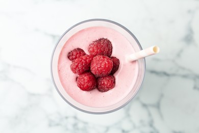 Yummy raspberry smoothie in glass on white marble table, top view Image of Yummy raspberry smoothie in glass on white marble table, top view