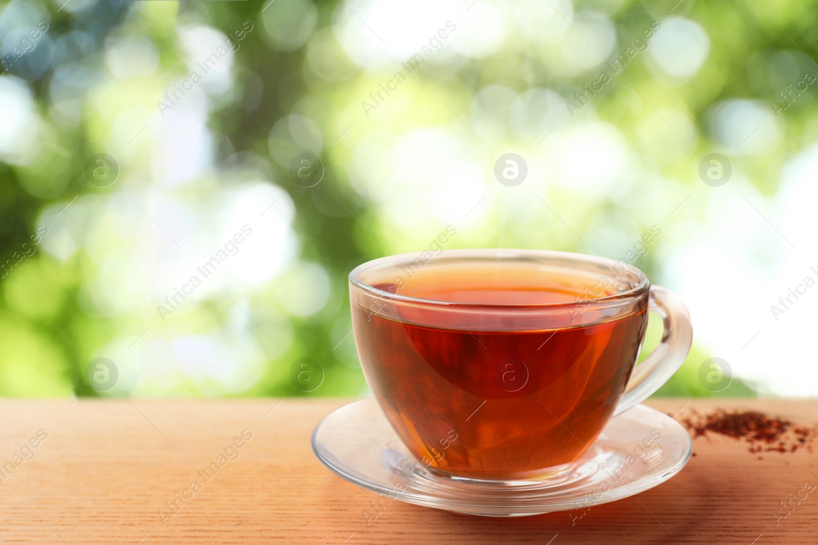 Cup of hot freshly brewed rooibos tea on wooden table outdoors Image of Cup of hot freshly brewed rooibos tea on wooden table outdoors
