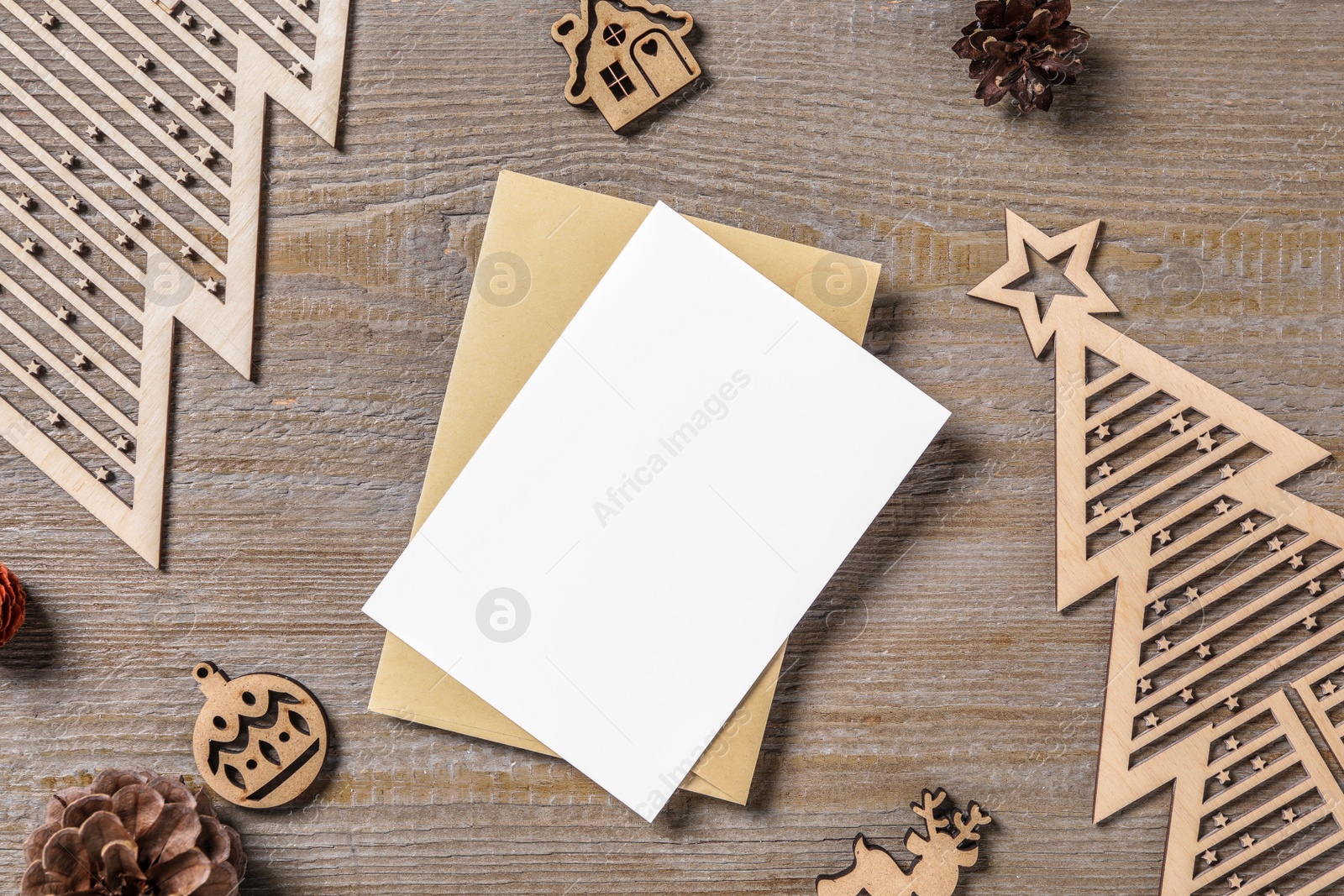Flat lay composition with blank greeting card and Christmas decor on wooden table, space for text Photo of Flat lay composition with blank greeting card and Christmas decor on wooden table, space for text