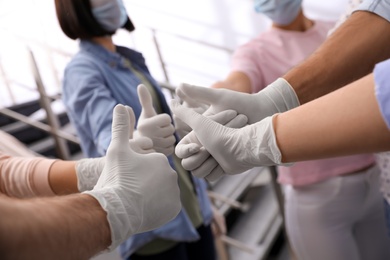 Group of people in white medical gloves showing thumbs up on blurred background, closeup Photo of Group of people in white medical gloves showing thumbs up on blurred background, closeup