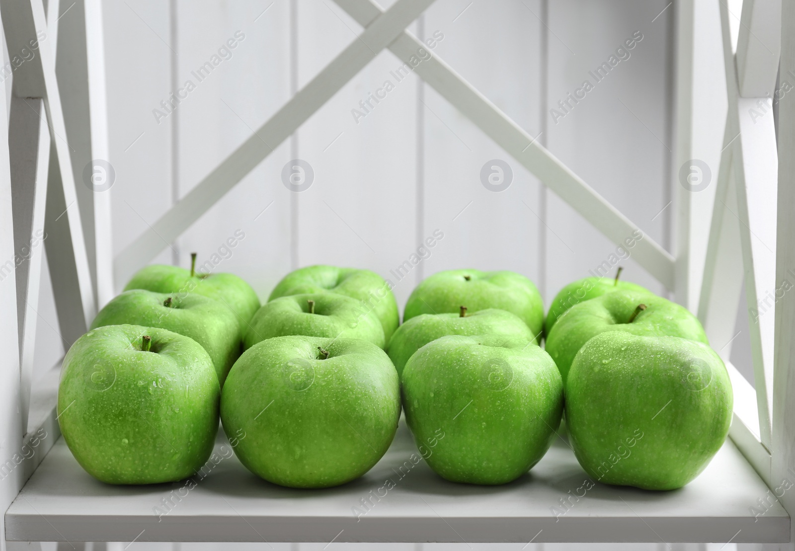 Fresh green apples on shelf Photo of Fresh green apples on shelf