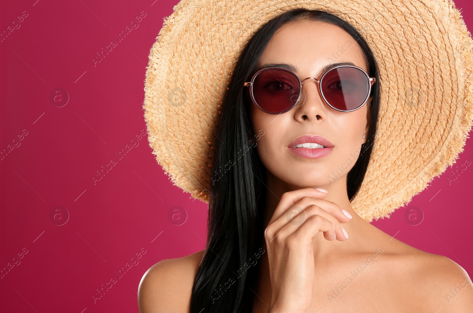 Beautiful woman wearing sunglasses on pink background Photo of Beautiful woman wearing sunglasses on pink background