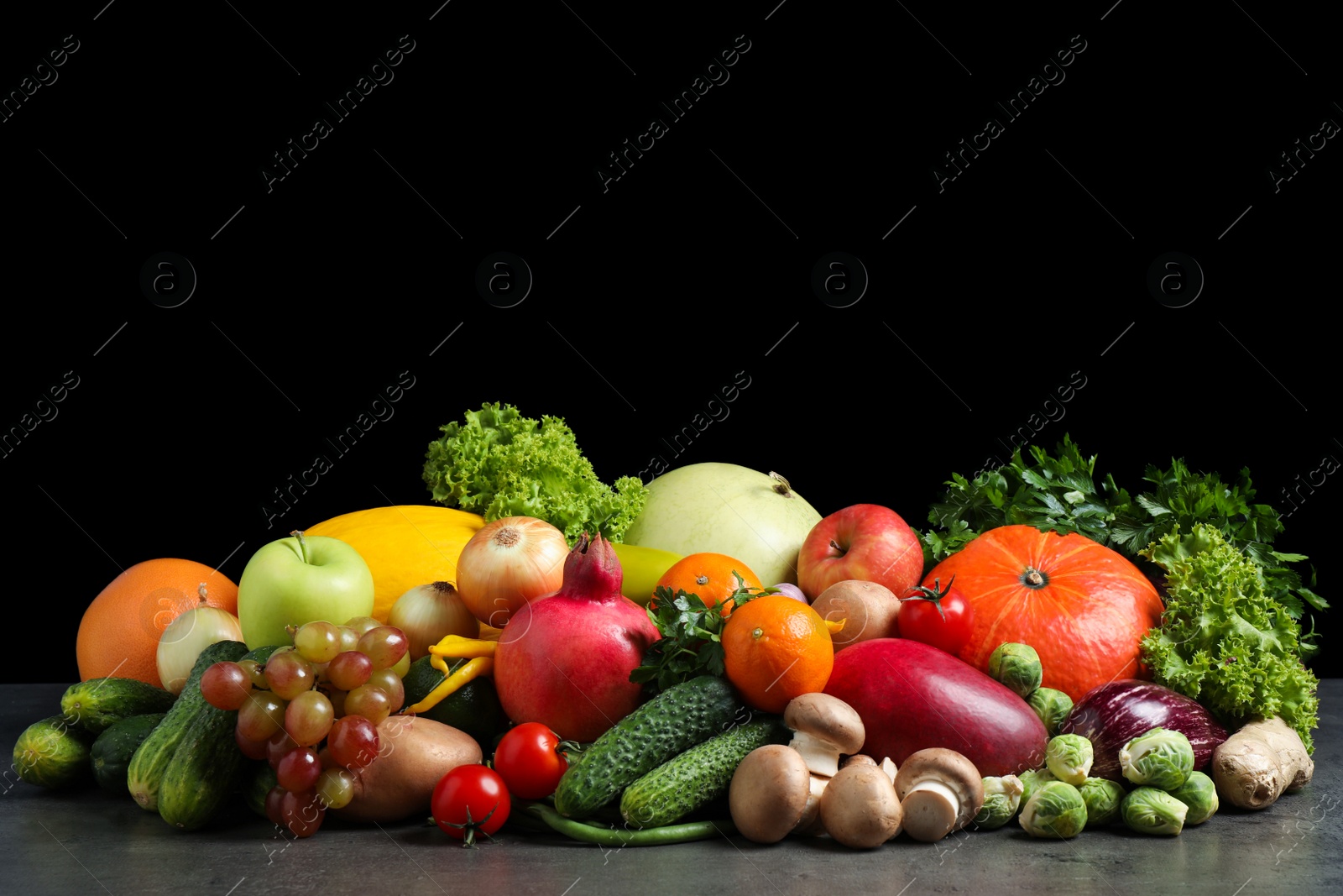 Assortment of fresh organic fruits and vegetables on grey table Photo of Assortment of fresh organic fruits and vegetables on grey table