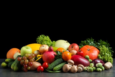 Assortment of fresh organic fruits and vegetables on grey table Photo of Assortment of fresh organic fruits and vegetables on grey table
