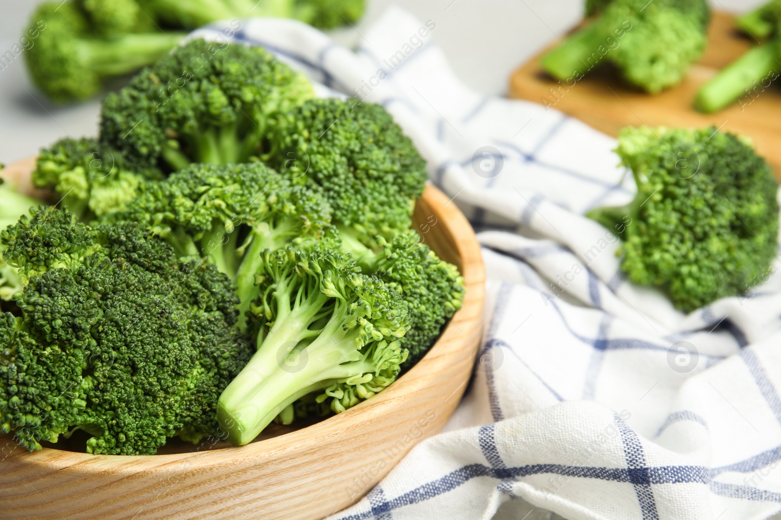 Fresh green broccoli in wooden bowl, closeup. Space for text Photo of Fresh green broccoli in wooden bowl, closeup. Space for text