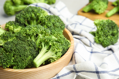 Fresh green broccoli in wooden bowl, closeup. Space for text Photo of Fresh green broccoli in wooden bowl, closeup. Space for text