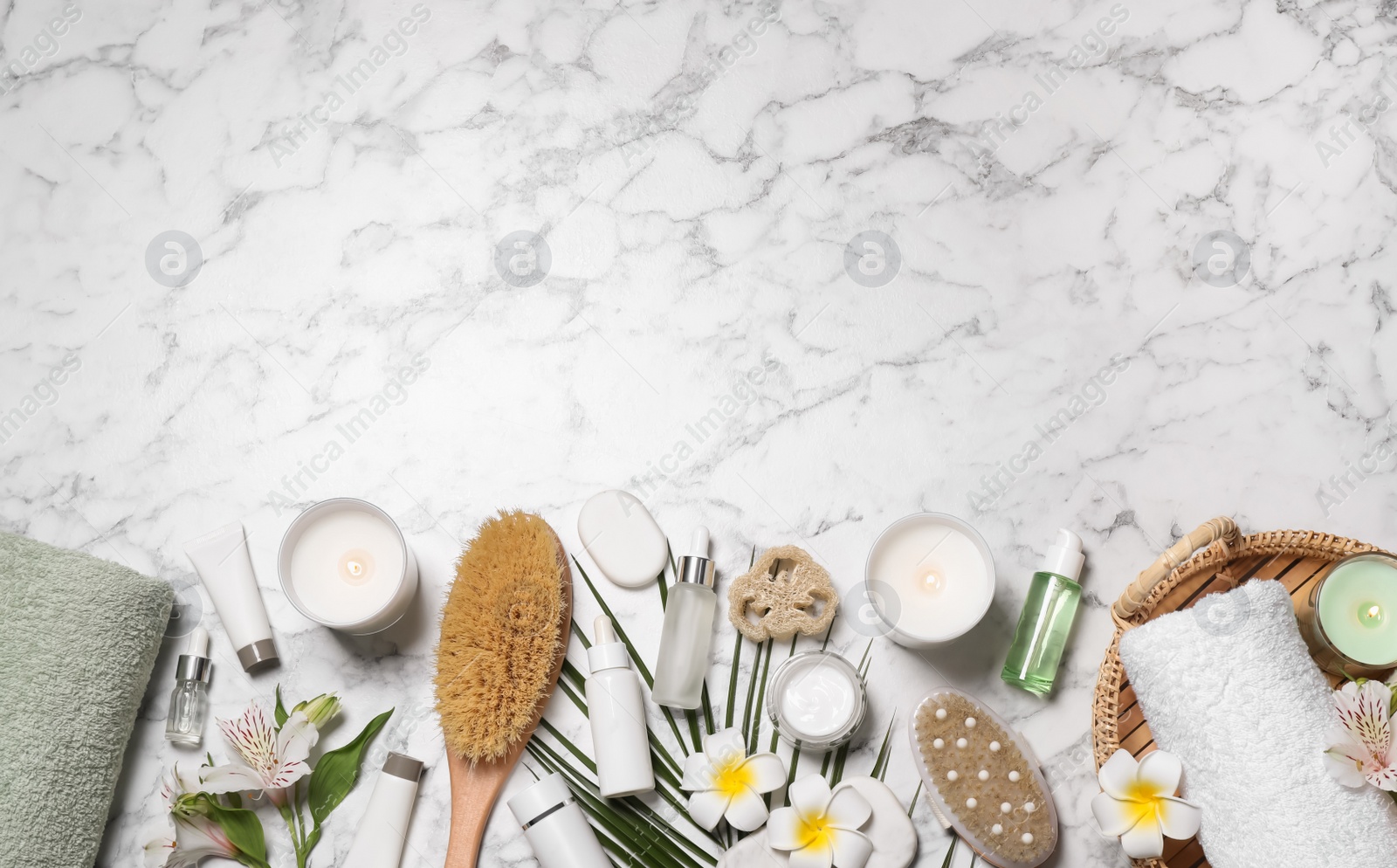 Flat lay composition with spa essentials on white marble background. Space for text Photo of Flat lay composition with spa essentials on white marble background. Space for text
