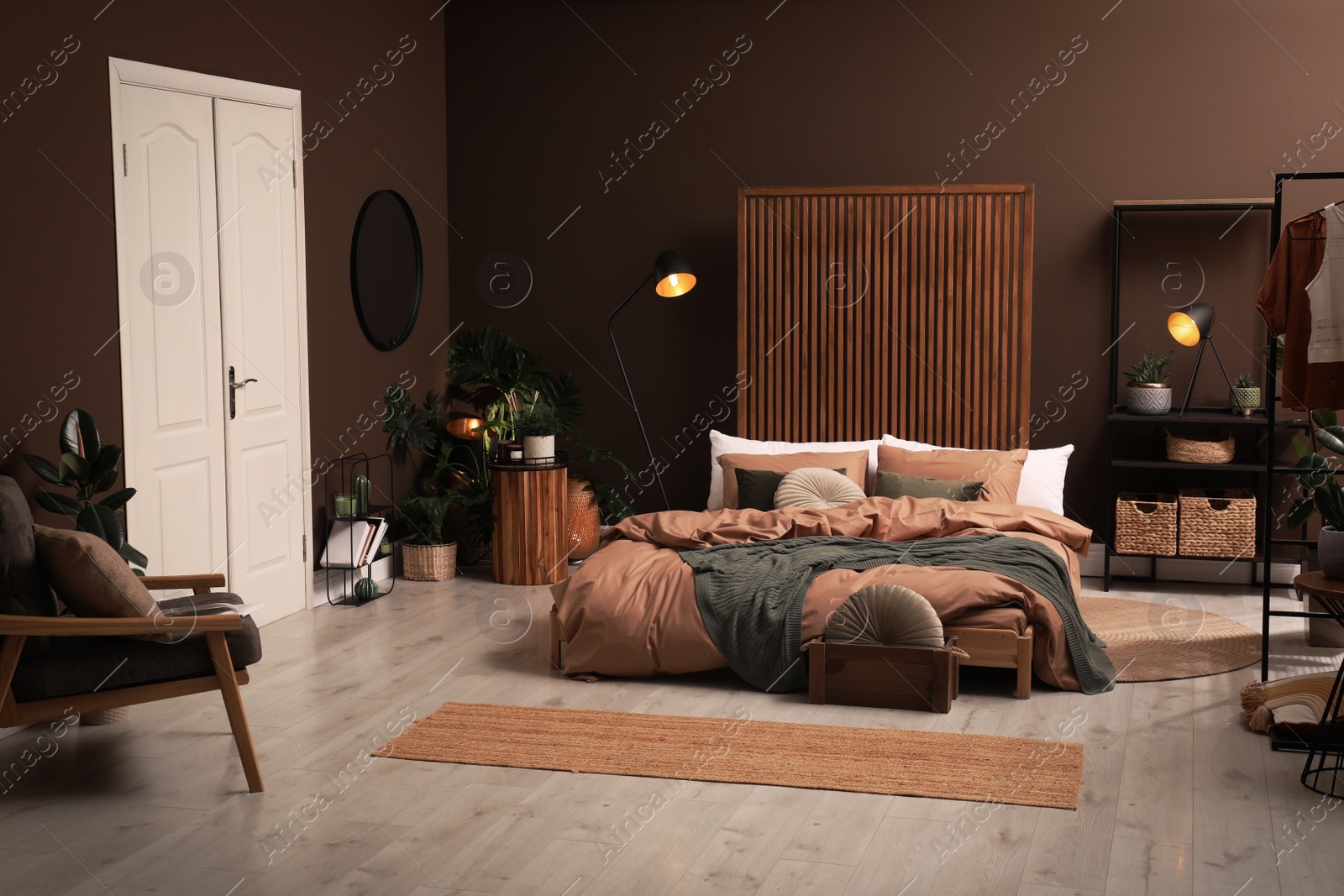 Stylish room interior with large bed near brown wall Photo of Stylish room interior with large bed near brown wall
