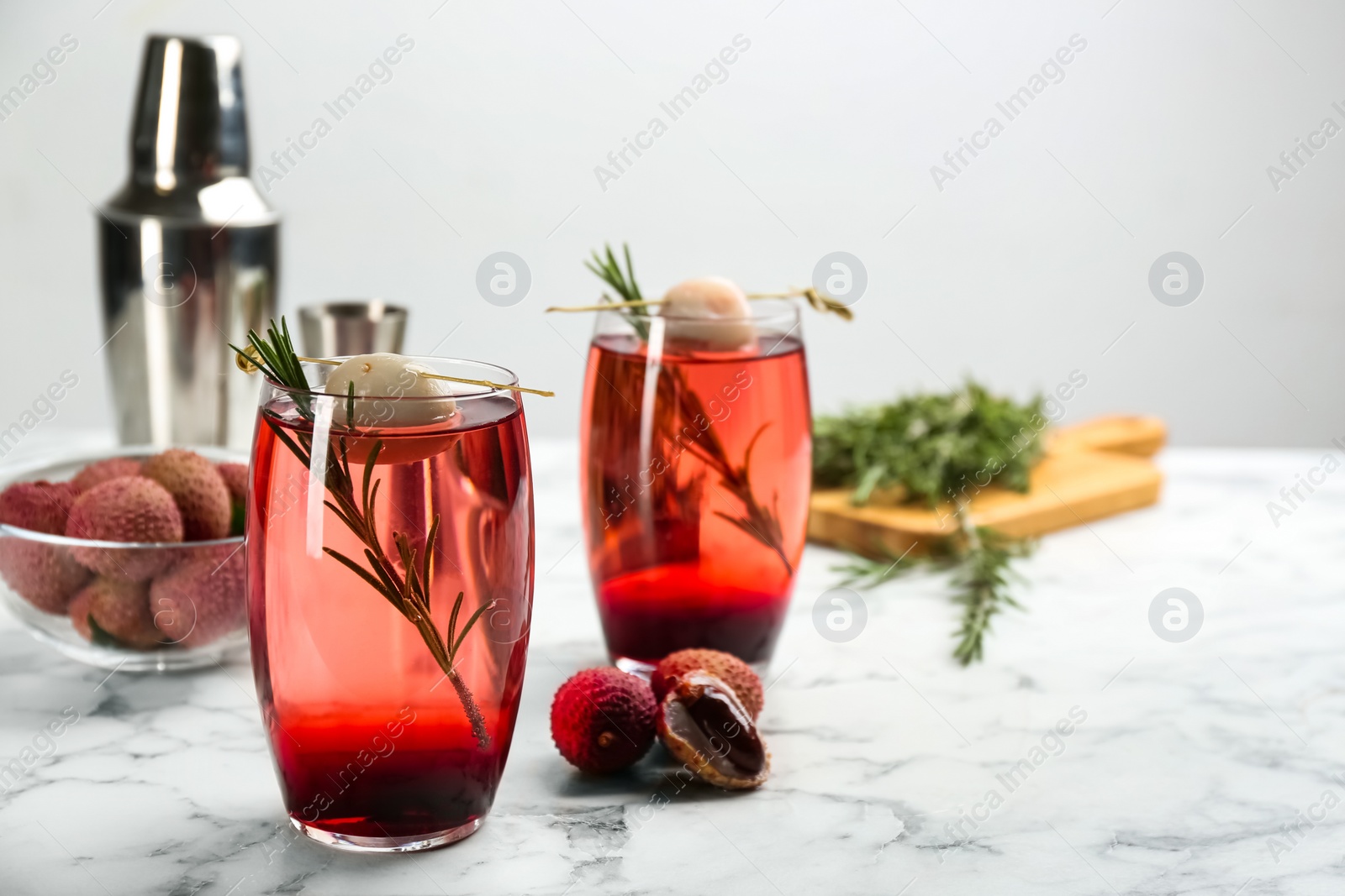 Delicious lychee cocktails and fresh ingredients on white marble table. Space for text Photo of Delicious lychee cocktails and fresh ingredients on white marble table. Space for text