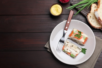 Delicious chicken aspic served on wooden table, flat lay. Space for text Photo of Delicious chicken aspic served on wooden table, flat lay. Space for text