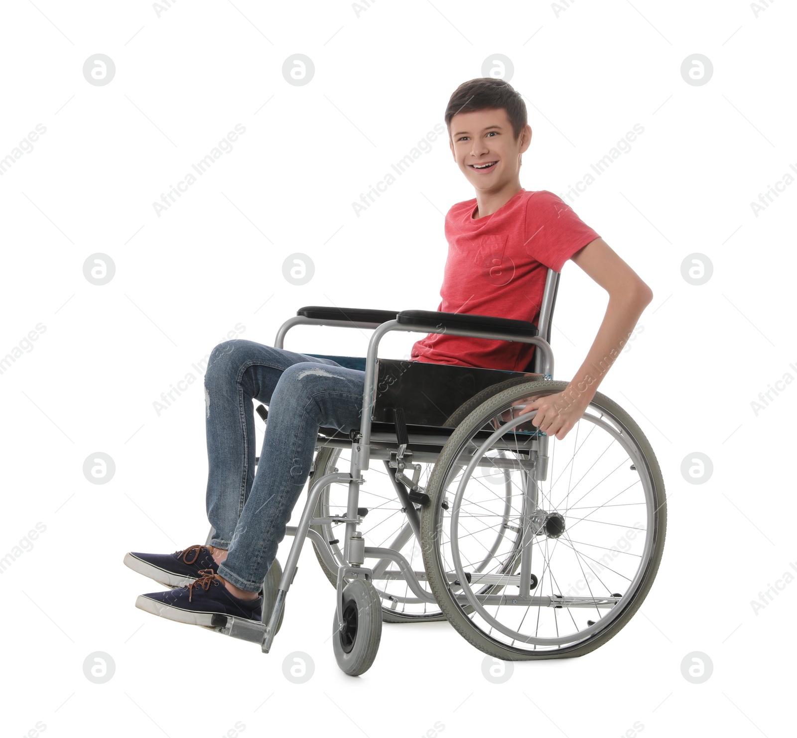 Teen boy in wheelchair on white background Photo of Teen boy in wheelchair on white background
