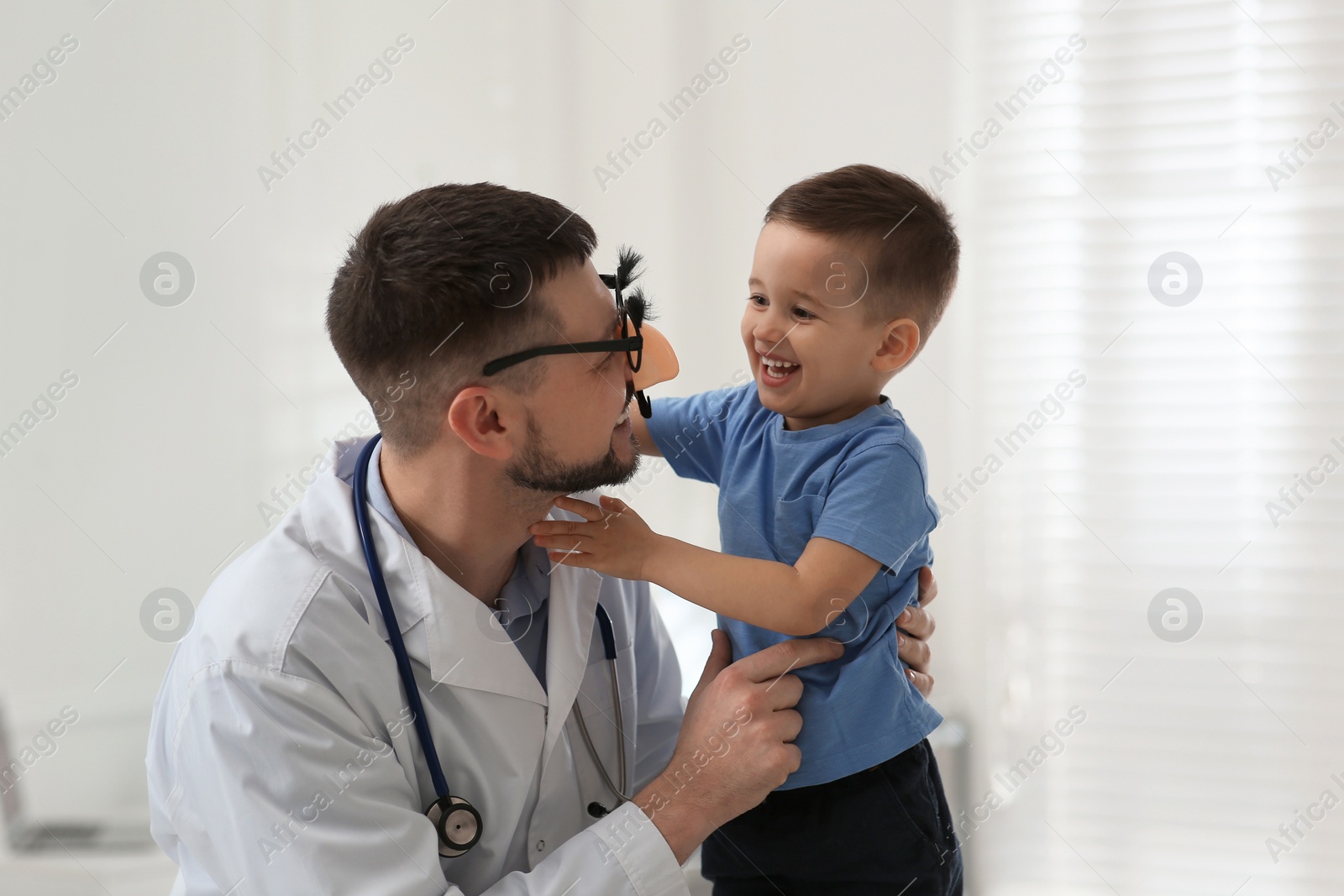 Pediatrician playing with little boy at hospital Photo of Pediatrician playing with little boy at hospital