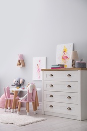 Children's room with modern furniture and pictures. Interior design Photo of Children's room with modern furniture and pictures. Interior design
