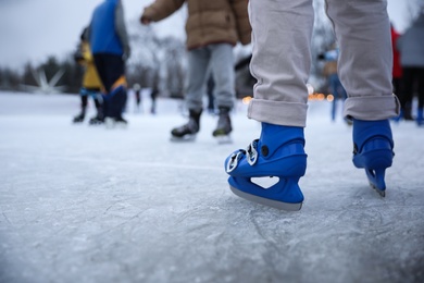Person skating at outdoor ice rink, closeup Photo of Person skating at outdoor ice rink, closeup