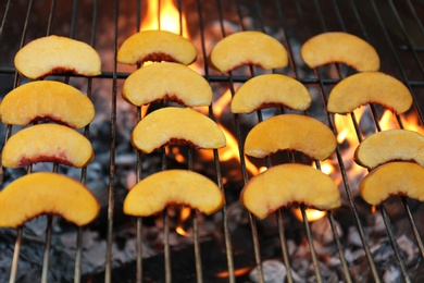 Modern grill with tasty peach slices, closeup Photo of Modern grill with tasty peach slices, closeup