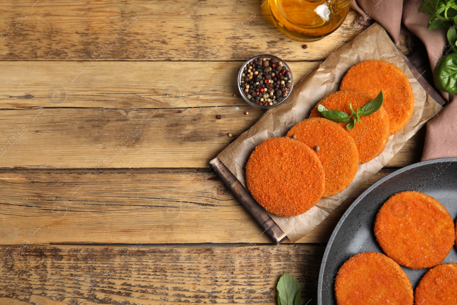 Delicious fried breaded cutlets served on wooden table, flat lay. Space for text Photo of Delicious fried breaded cutlets served on wooden table, flat lay. Space for text