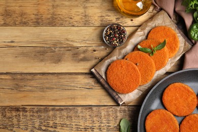 Delicious fried breaded cutlets served on wooden table, flat lay. Space for text Photo of Delicious fried breaded cutlets served on wooden table, flat lay. Space for text