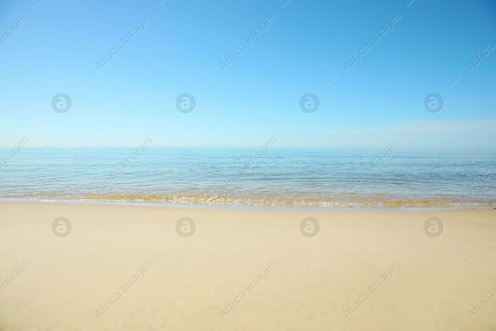 Beautiful sandy beach and sea under blue sky, closeup Photo of Beautiful sandy beach and sea under blue sky, closeup