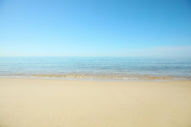 Beautiful sandy beach and sea under blue sky, closeup Photo of Beautiful sandy beach and sea under blue sky, closeup