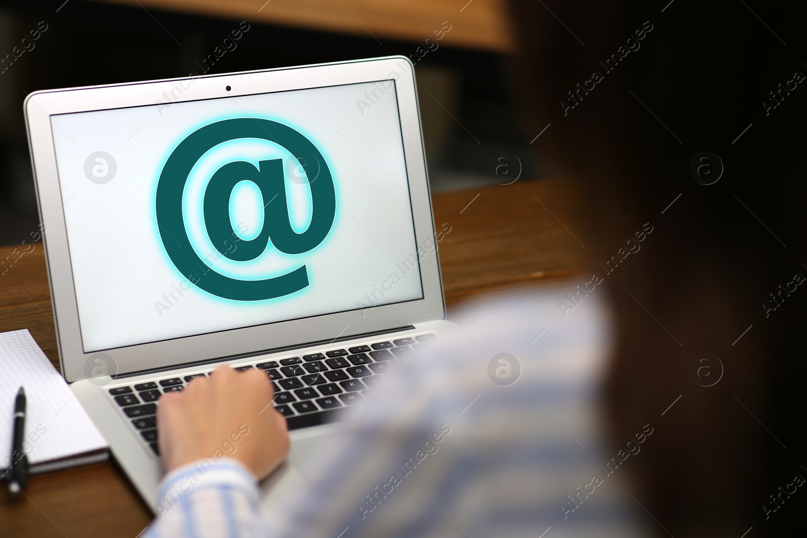 Woman sending email via laptop at table, closeup Image of Woman sending email via laptop at table, closeup