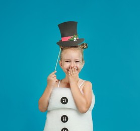 Cute little girl dressed as snowman on light blue background. Christmas suit Image of Cute little girl dressed as snowman on light blue background. Christmas suit