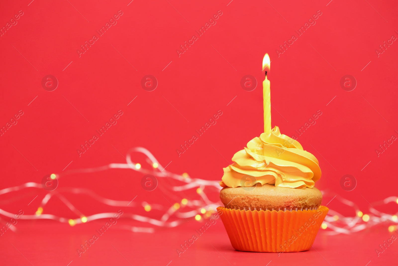 Birthday cupcake with candle on color background Photo of Birthday cupcake with candle on color background