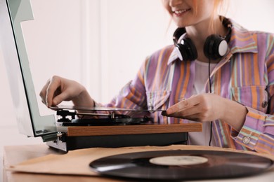 Young woman using turntable at home, closeup Photo of Young woman using turntable at home, closeup