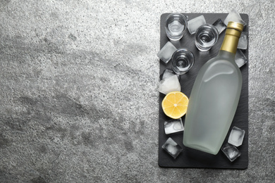 Cold Russian vodka on grey table, top view. Space for text Photo of Cold Russian vodka on grey table, top view. Space for text