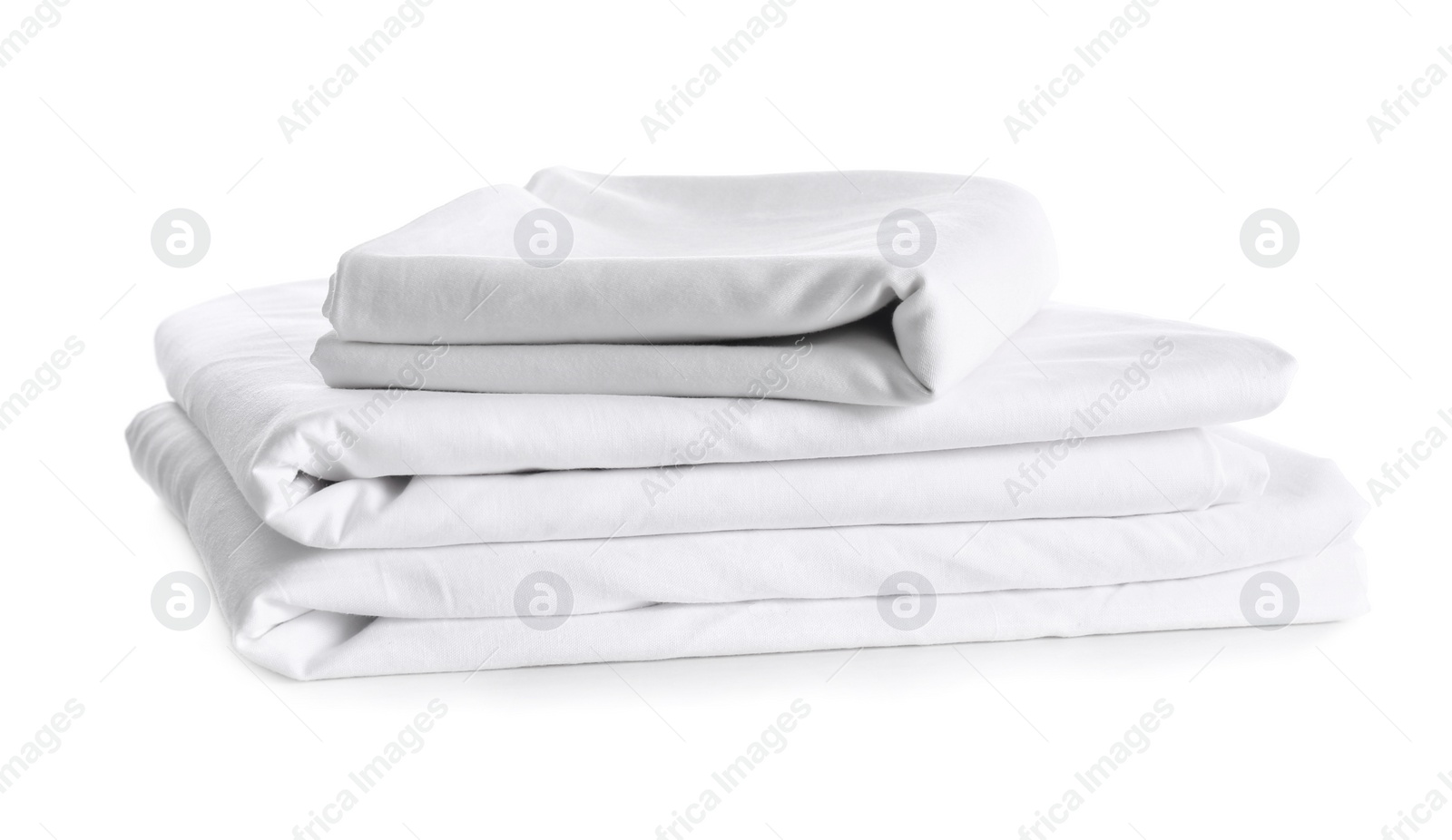 Stack of clean bed linen isolated on white Photo of Stack of clean bed linen isolated on white