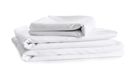 Stack of clean bed linen isolated on white Photo of Stack of clean bed linen isolated on white