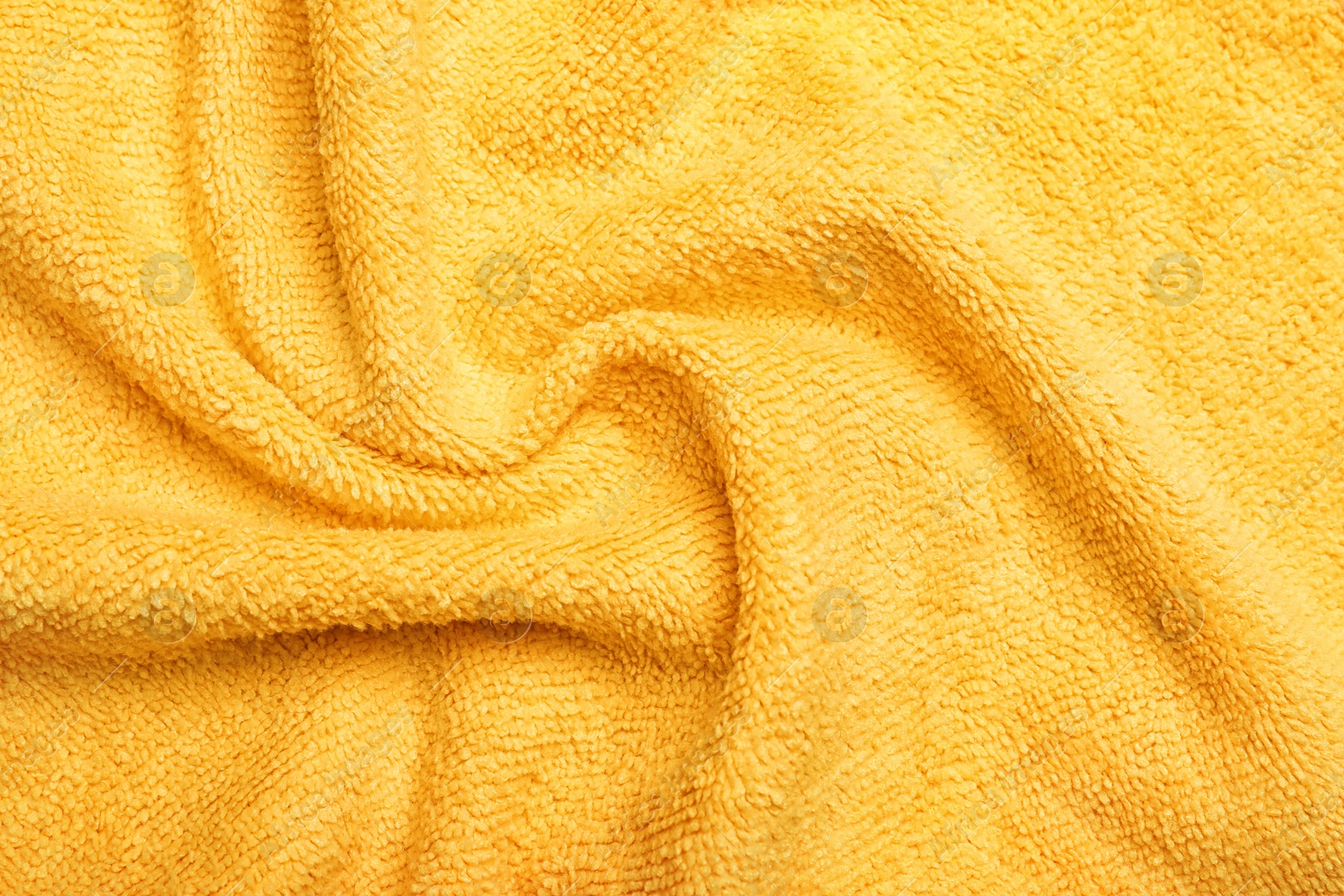 Crumpled orange microfiber cloth as background, closeup Photo of Crumpled orange microfiber cloth as background, closeup