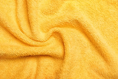 Crumpled orange microfiber cloth as background, closeup Photo of Crumpled orange microfiber cloth as background, closeup