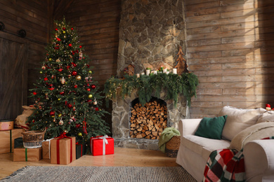 Festive interior with decorated Christmas tree and fireplace Photo of Festive interior with decorated Christmas tree and fireplace