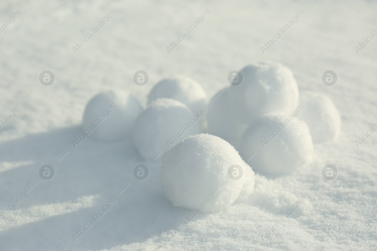 Pile of perfect round snowballs on snow outdoors Photo of Pile of perfect round snowballs on snow outdoors