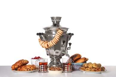 Traditional Russian samovar with treats isolated on white Photo of Traditional Russian samovar with treats isolated on white