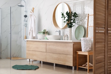 Modern bathroom interior with stylish mirror and vessel sink Photo of Modern bathroom interior with stylish mirror and vessel sink