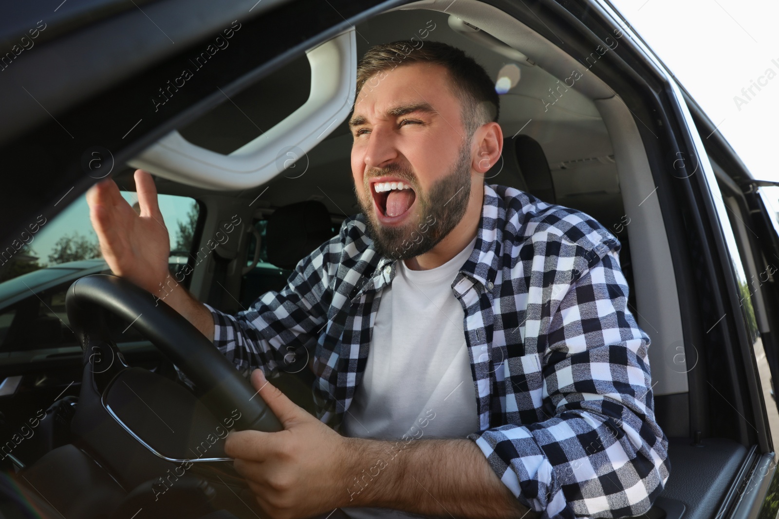 Emotional man in car. Aggressive driving behavior Photo of Emotional man in car. Aggressive driving behavior