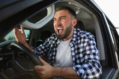 Emotional man in car. Aggressive driving behavior Photo of Emotional man in car. Aggressive driving behavior