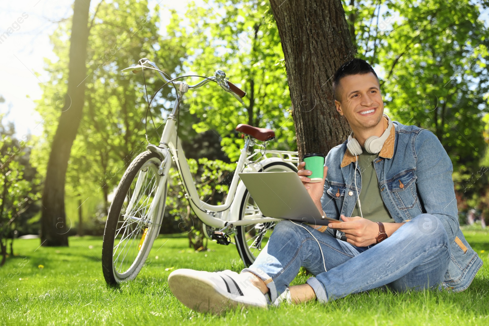 Man taking coffee break during work in park Photo of Man taking coffee break during work in park